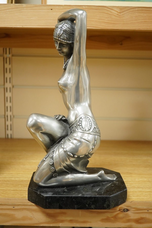 An Art Deco style figure of semi nude woman, raised on shaped marble base, in the style of Giuseppe Bessi, 37cm high. Condition - good